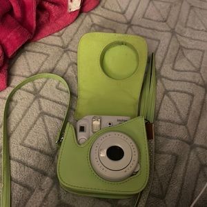 Instax gray Polaroid camera with green case